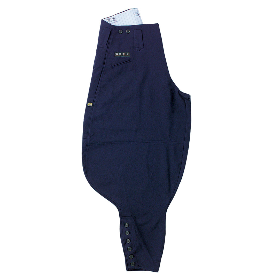 Front view of Toraichi seven-quarter tobi pants in navy, showing loose fit and tapered hem