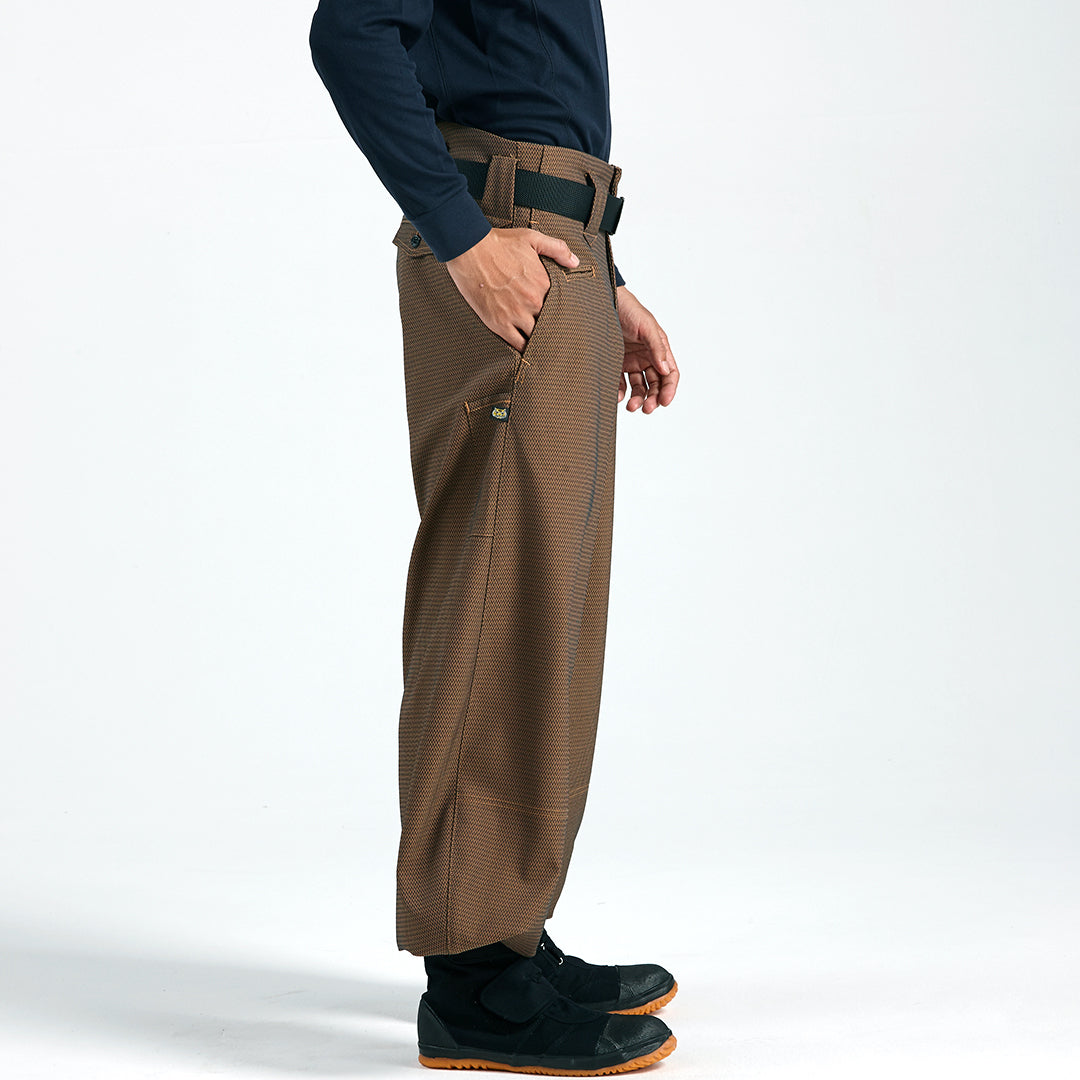 Side profile of brown slim super-long hachibu tobi pants with textured fabric