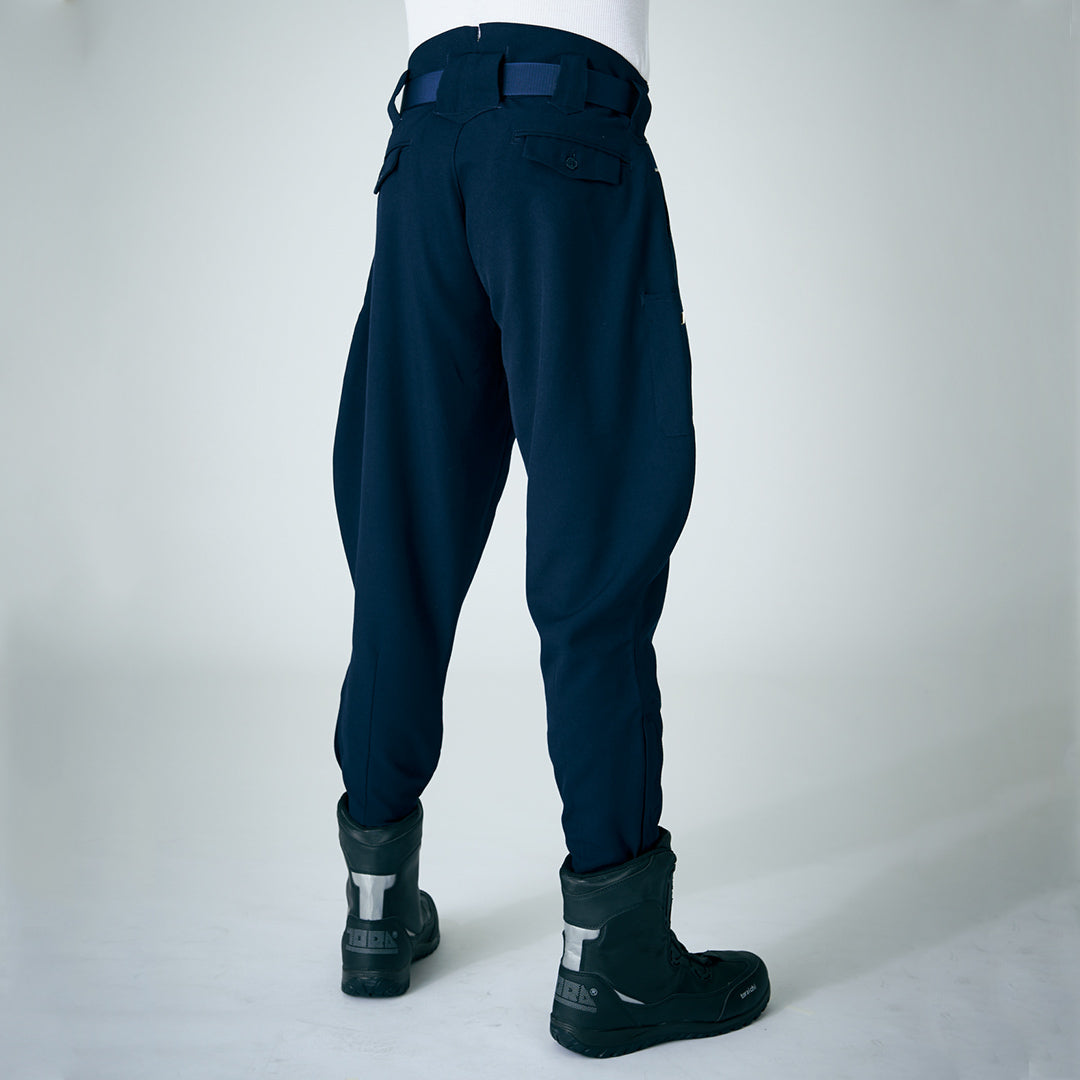 Back view of navy Toraichi tobi pants styled with tall black work boots