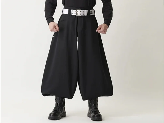 Black tobi pants with wide-leg silhouette paired with black boots