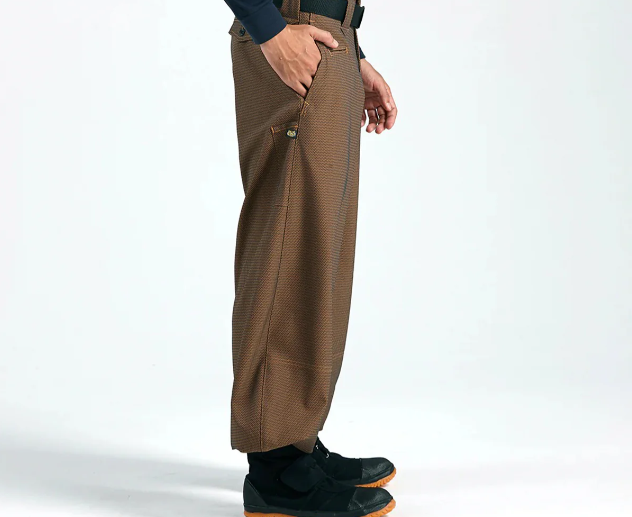Brown patterned tobi pants with tapered fit and side pocket, worn with black work shoes