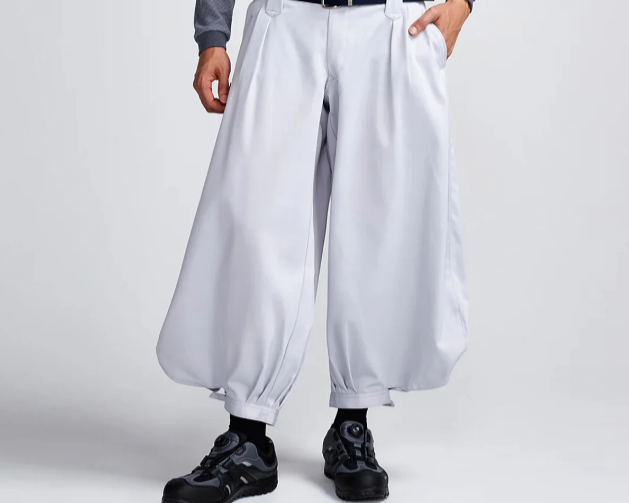 Light gray tobi pants with wide-leg silhouette and gathered cuffs paired with black work shoes
