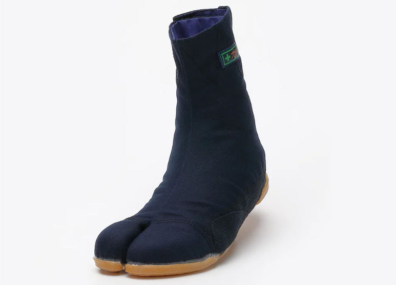 A navy blue split-toe Japanese work boot with a light brown sole, shown at an angle against a plain light gray background.