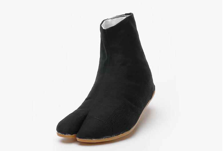 A black split-toe Japanese work boot with a light brown sole, shown at an angle against a plain light gray background.