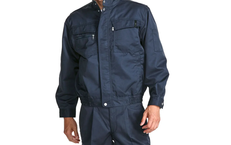 A model wearing a navy blue work jacket with a stand collar, front zipper, and zippered chest pockets, shown against a light gray background.