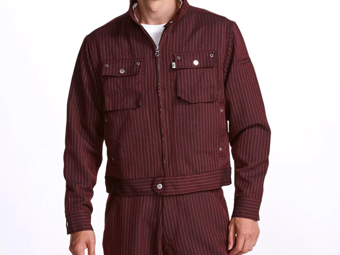 A model wearing a burgundy pinstripe work jacket with a stand collar, front zipper, and flap chest pockets, shown against a light gray background.