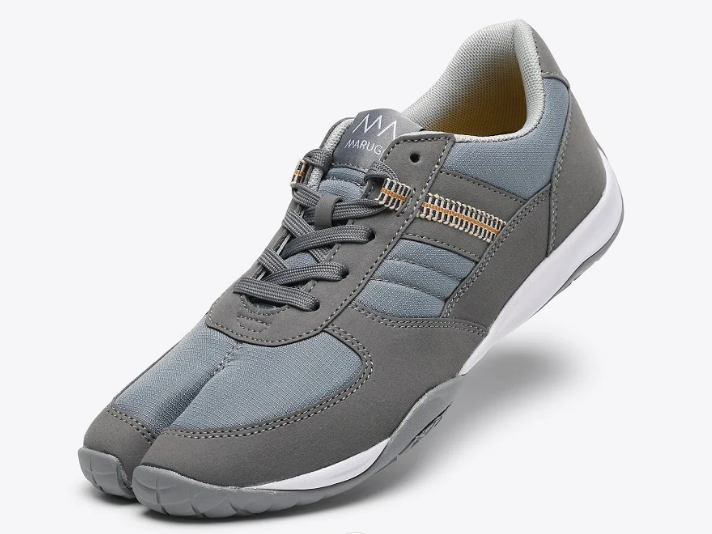 A gray split-toe lace-up work shoe with a white sole, shown at an angle against a light gray background.