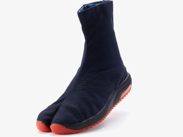 A navy blue split-toe Japanese work boot with a black sole and bright orange tread, shown at an angle against a plain light gray background.