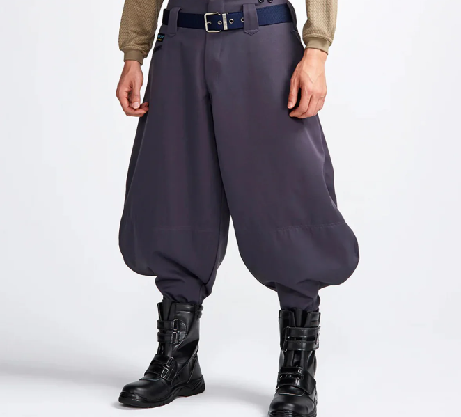 A model wearing dark gray balloon-style Japanese work pants with a belt and black work boots, shown against a light gray background.