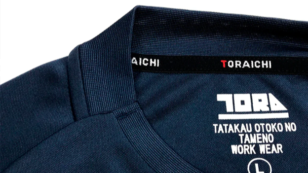 Close-up of a dark navy Toraichi workwear shirt collar with the brand label and size marking visible inside.