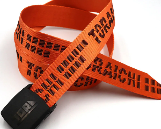 Bright orange Toraichi workwear belt with black lettering and a black buckle, shown looped on a plain white background.