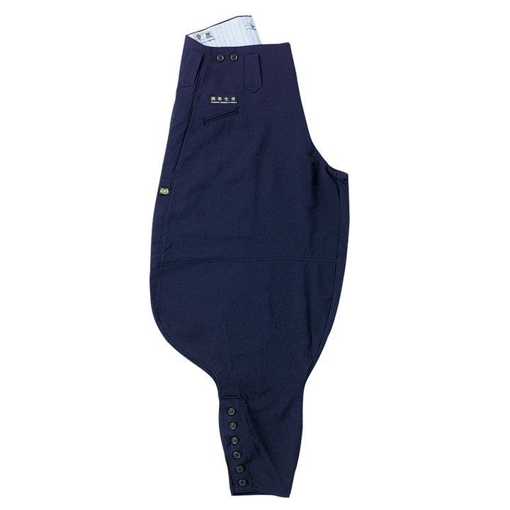 Front view of Toraichi seven-quarter tobi pants in navy, showing loose fit and tapered hem