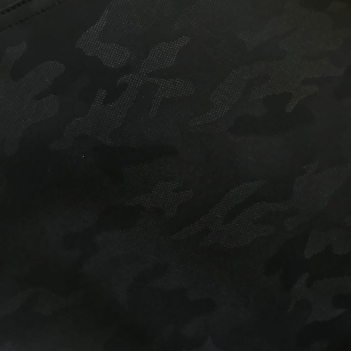Close-up of camo-textured fabric on black Toraichi tobi pants