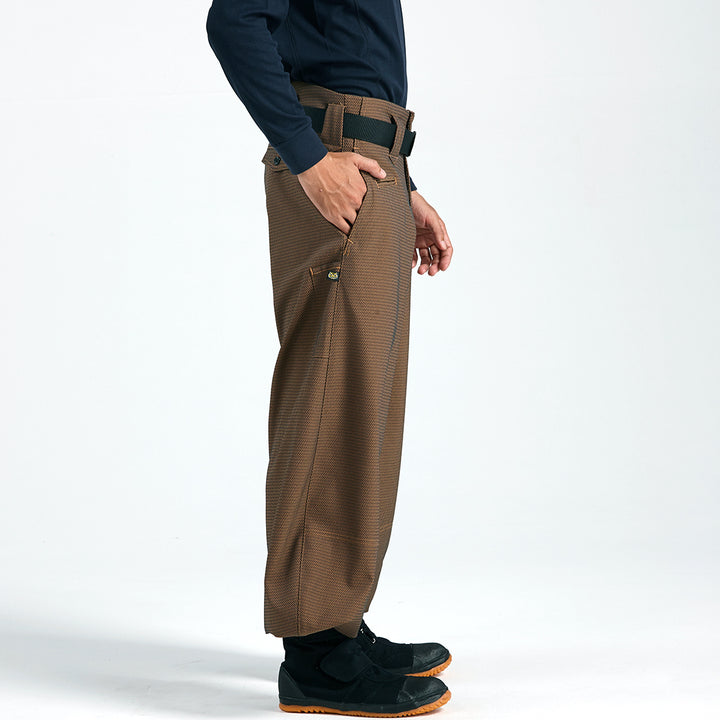 Side profile of brown slim super-long hachibu tobi pants with textured fabric