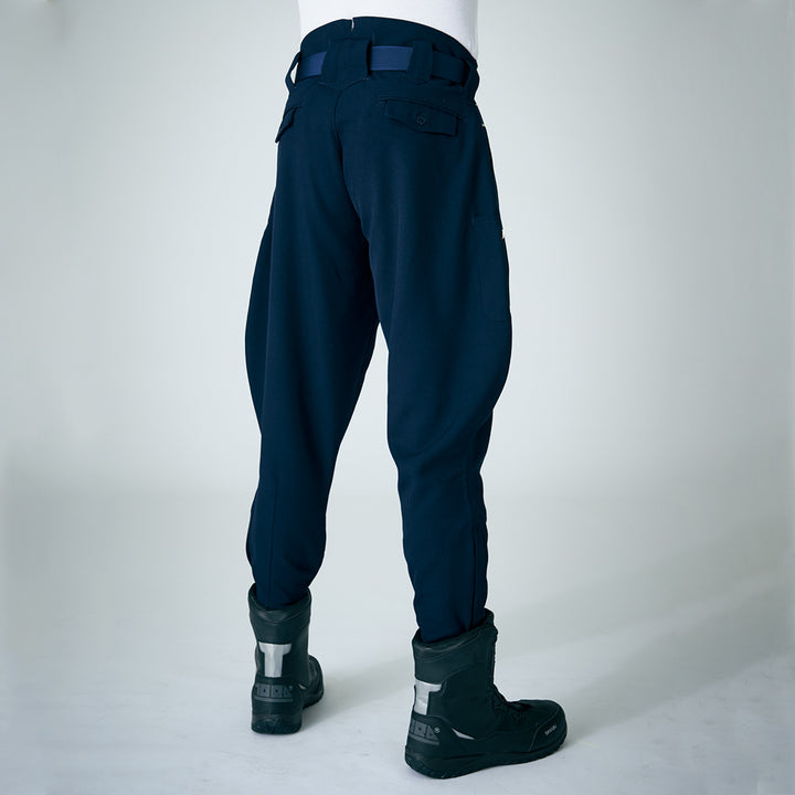 Back view of navy Toraichi tobi pants styled with tall black work boots