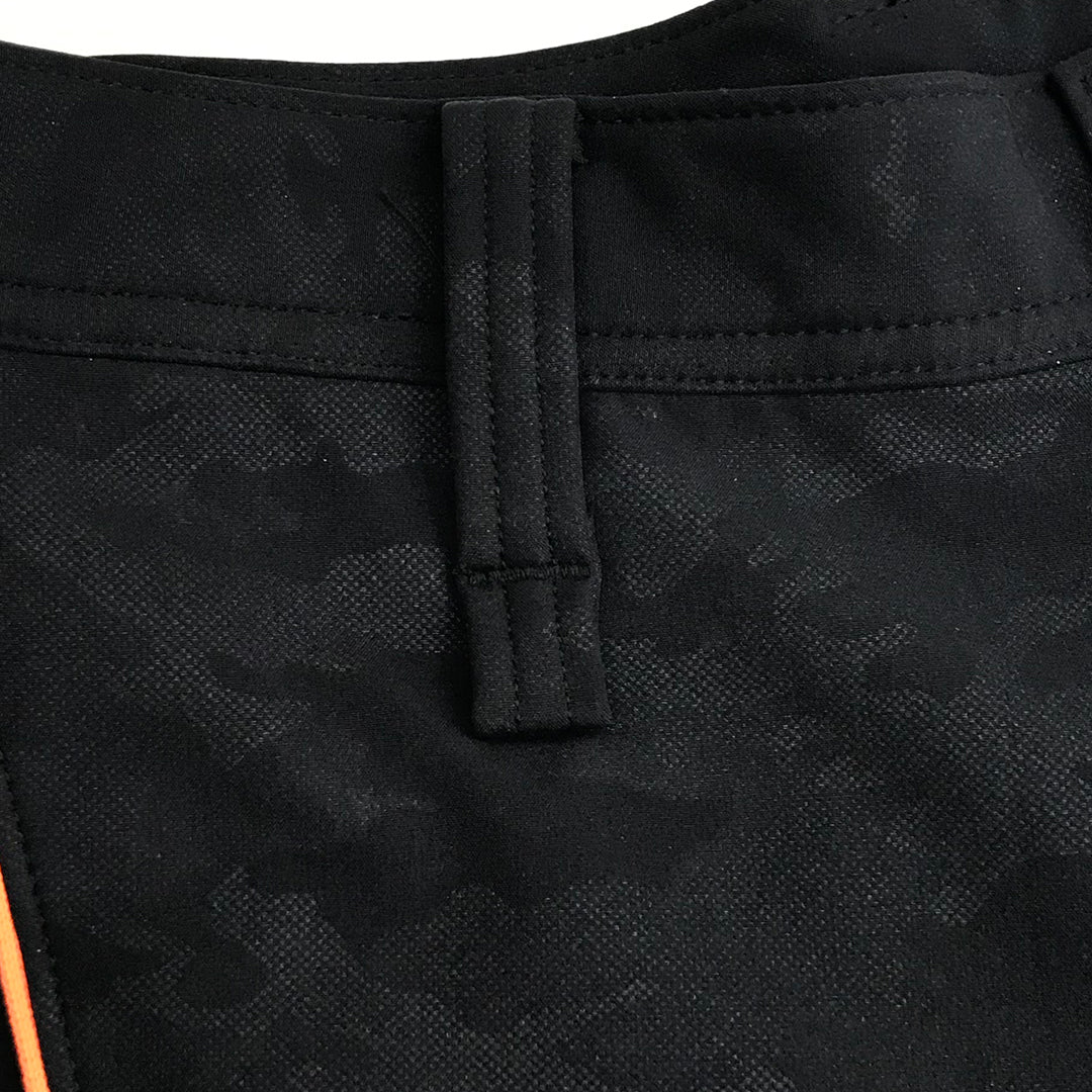 Back pocket close-up on the Toraichi Japanese workwear pants showing reinforced rivets and structured fabric finish.