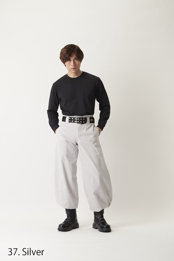 Model wearing slim super long hachibu trousers with wide belt and boots