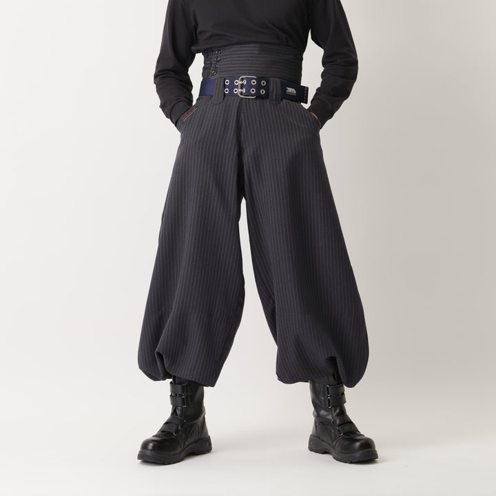 Model wearing high-waisted Japanese tobi pants in dark navy with wide silhouette