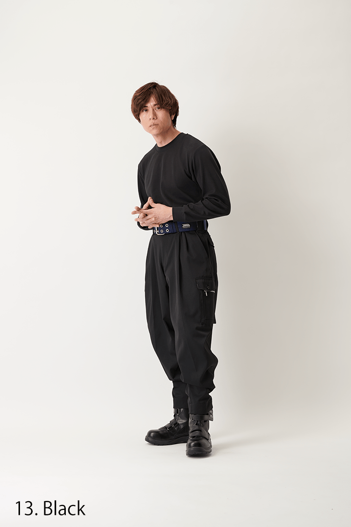 High-waist K-1 utility trousers paired with a black top and rugged footwear