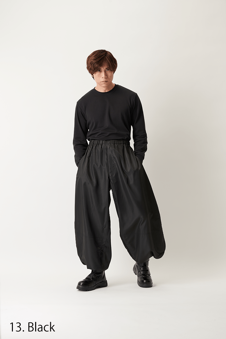 Side view of black Toraichi Yakke pants paired with work boots