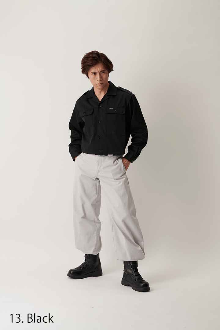 Model wearing black short open shirt with white trousers