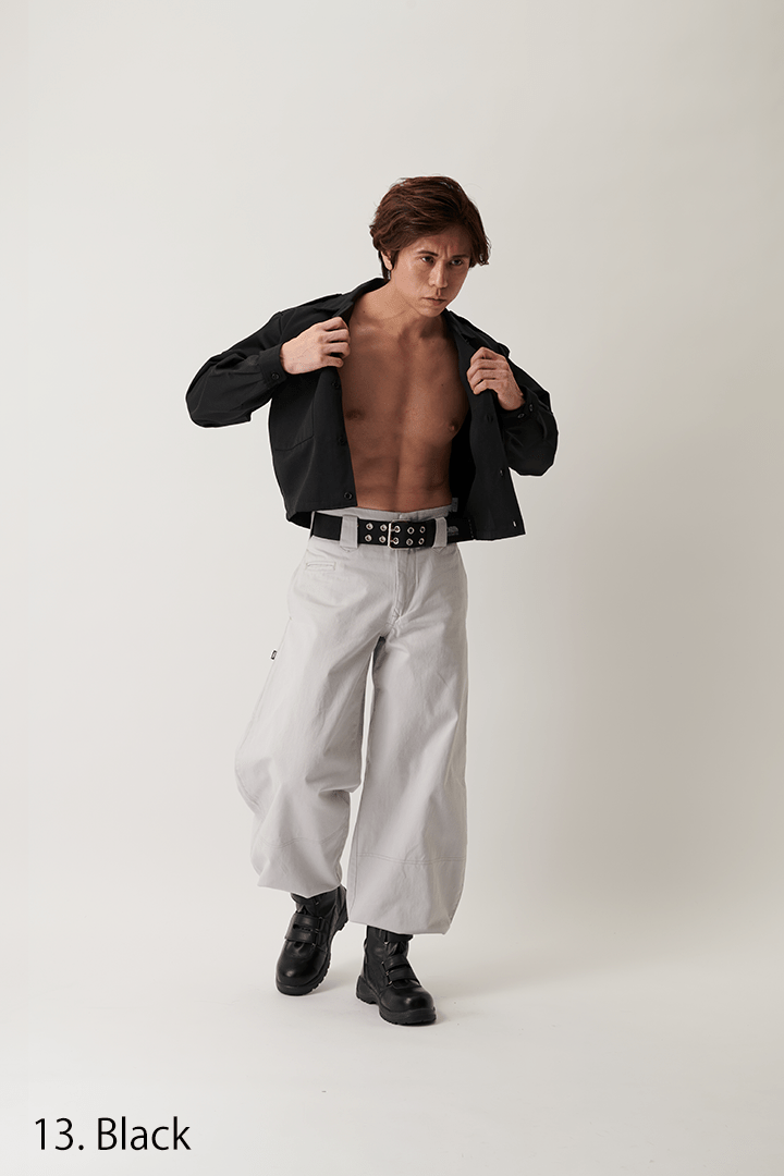 Model walking outdoors wearing black short open shirt
