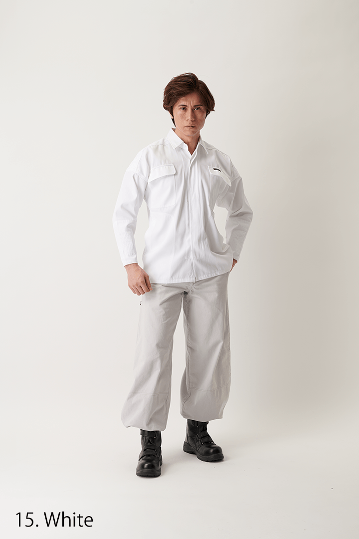 Model standing on seaside rocks wearing a crisp white tobi shirt