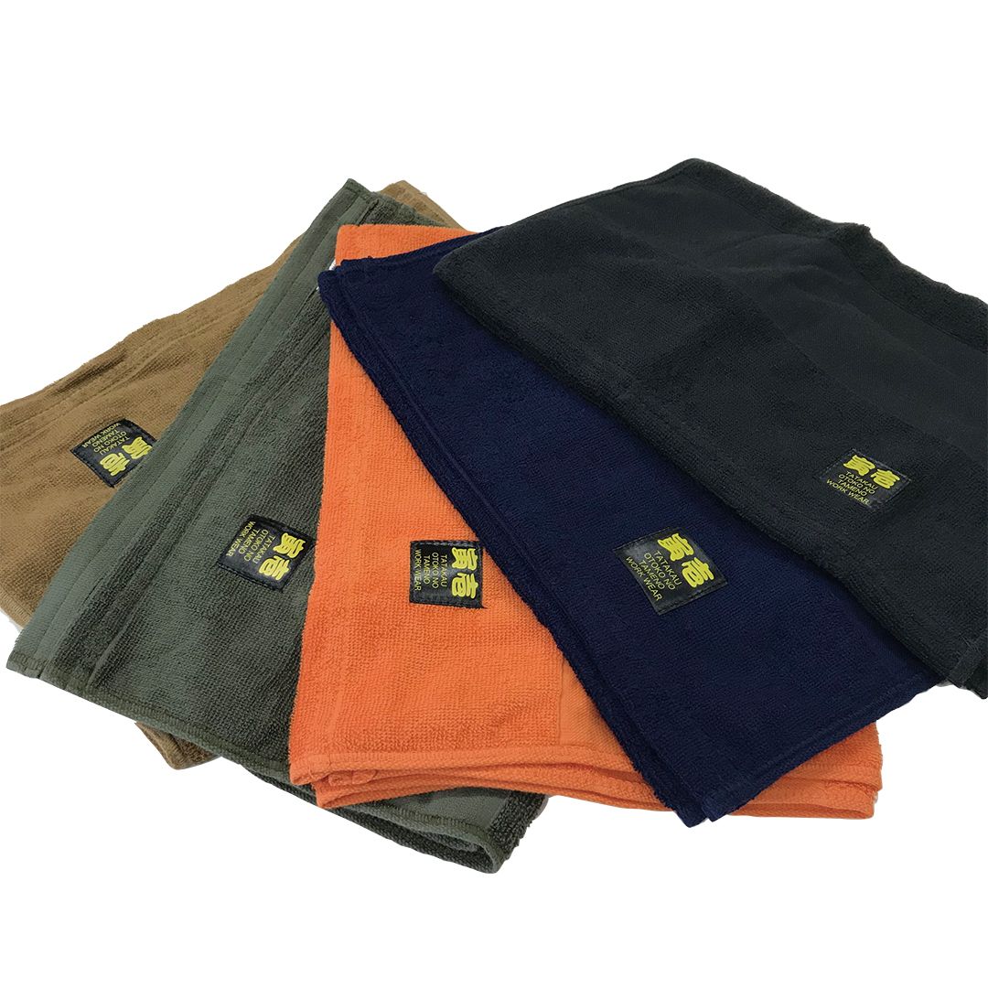 Close-up of Toraichi towels showing fabric texture and workwear branding tag