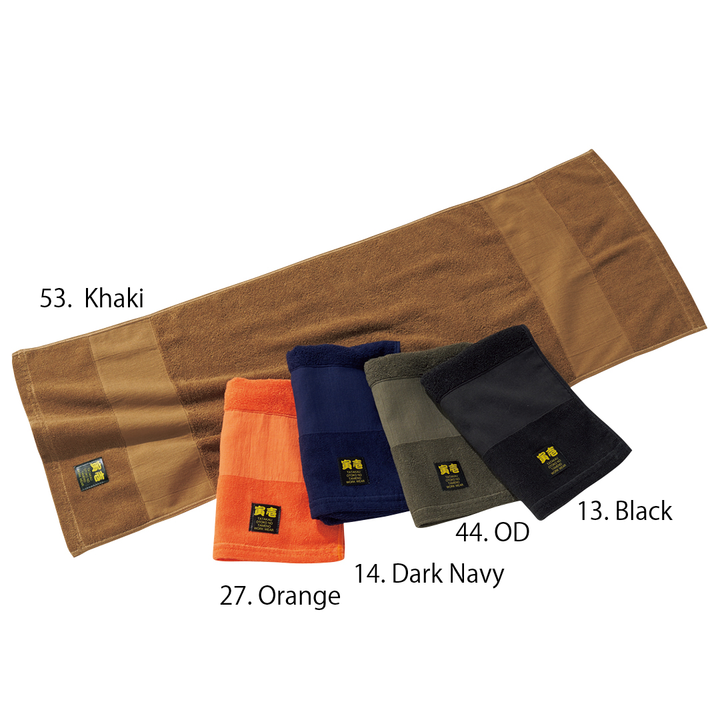 Folded Toraichi towels in assorted colors with visible woven labels