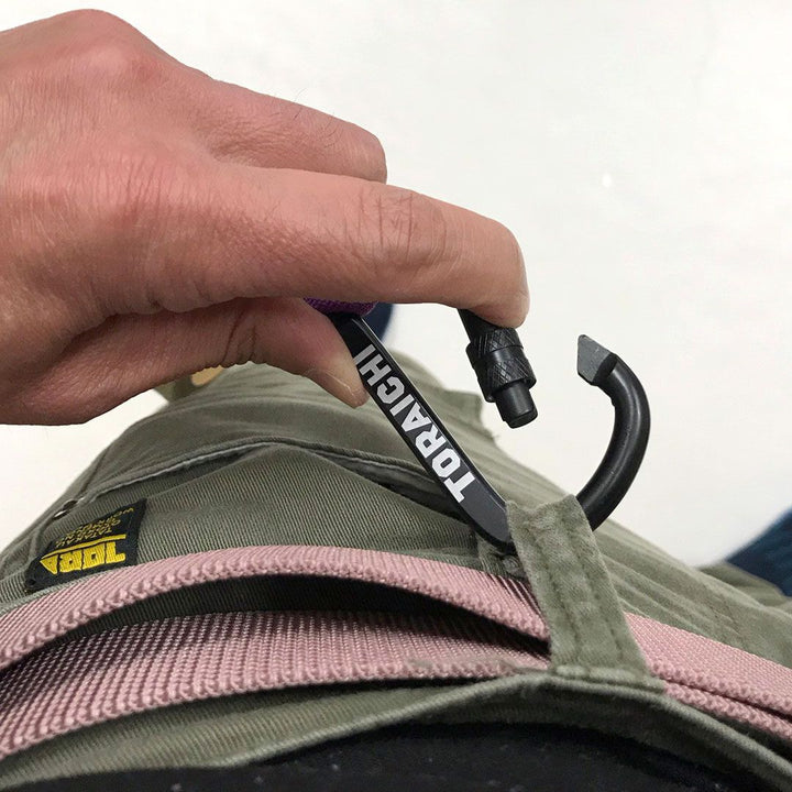 Worker demonstrating Toraichi tape holder on utility pants