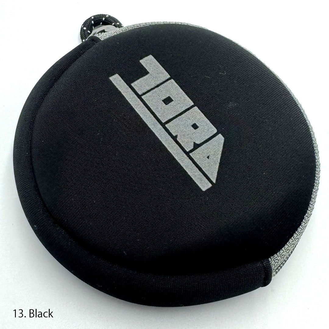 Round Toraichi coin case closed, minimalist design emphasizing Japanese workwear quality and practicality