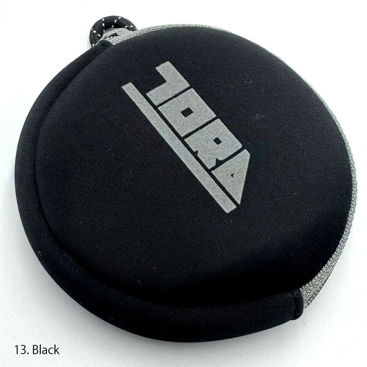 Round Toraichi coin case closed, minimalist design emphasizing Japanese workwear quality and practicality