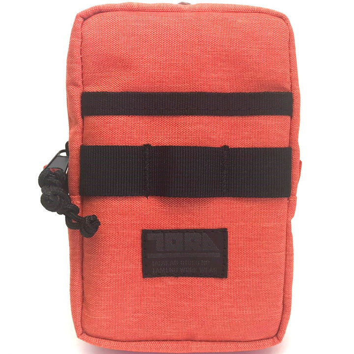 Close-up of Toraichi multifunctional storage case in orange with black webbing straps