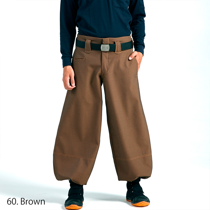 Model wearing brown eight-quarter Japanese work pants with wide cut