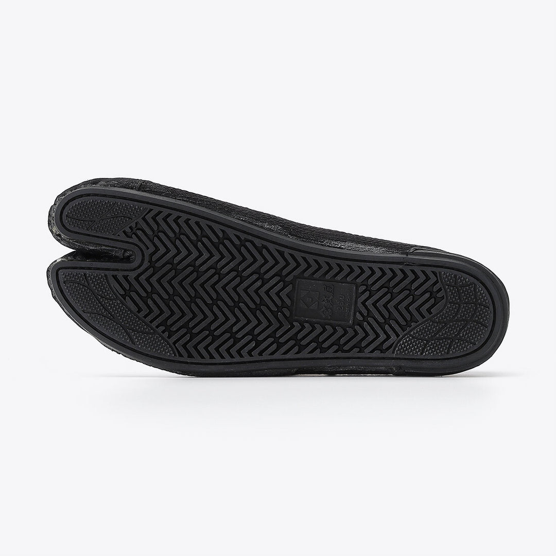 Side profile of black Tabi work boots showing minimalist silhouette