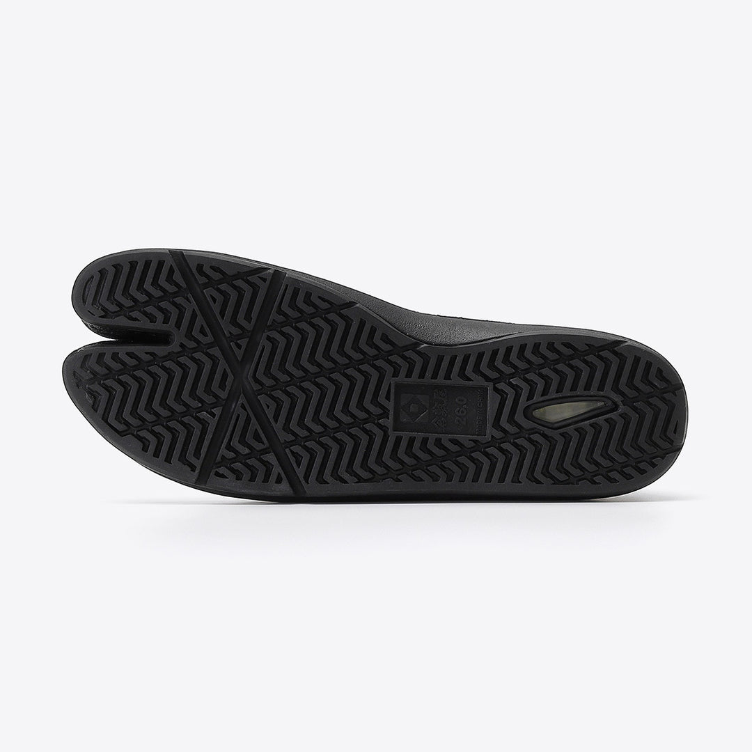 Flat lay of black Japanese Tabi footwear showing split-toe construction