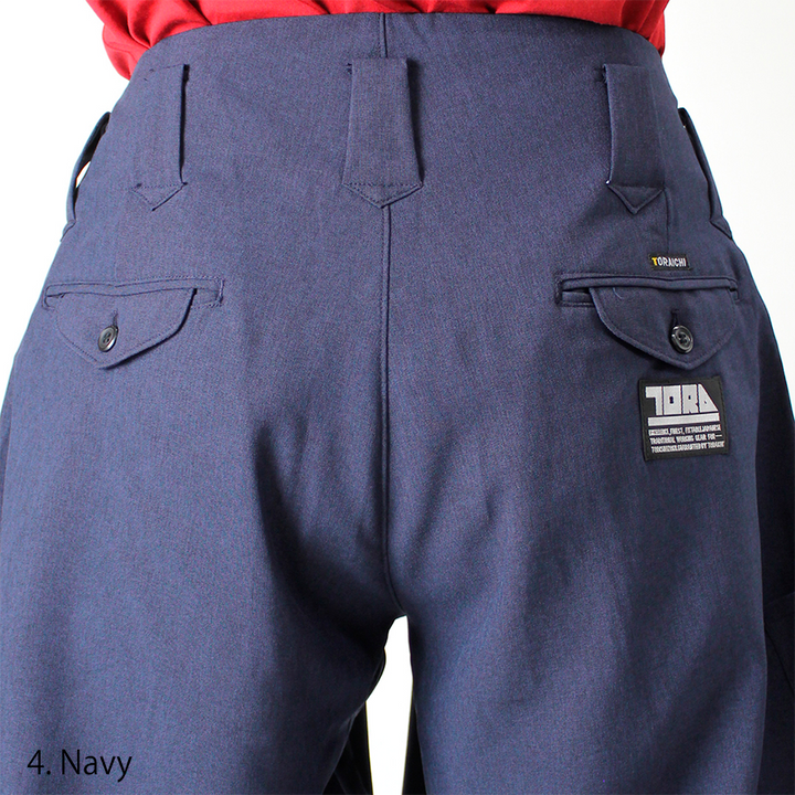 Model wearing Toraichi navy seven-quarter pants styled with black boots