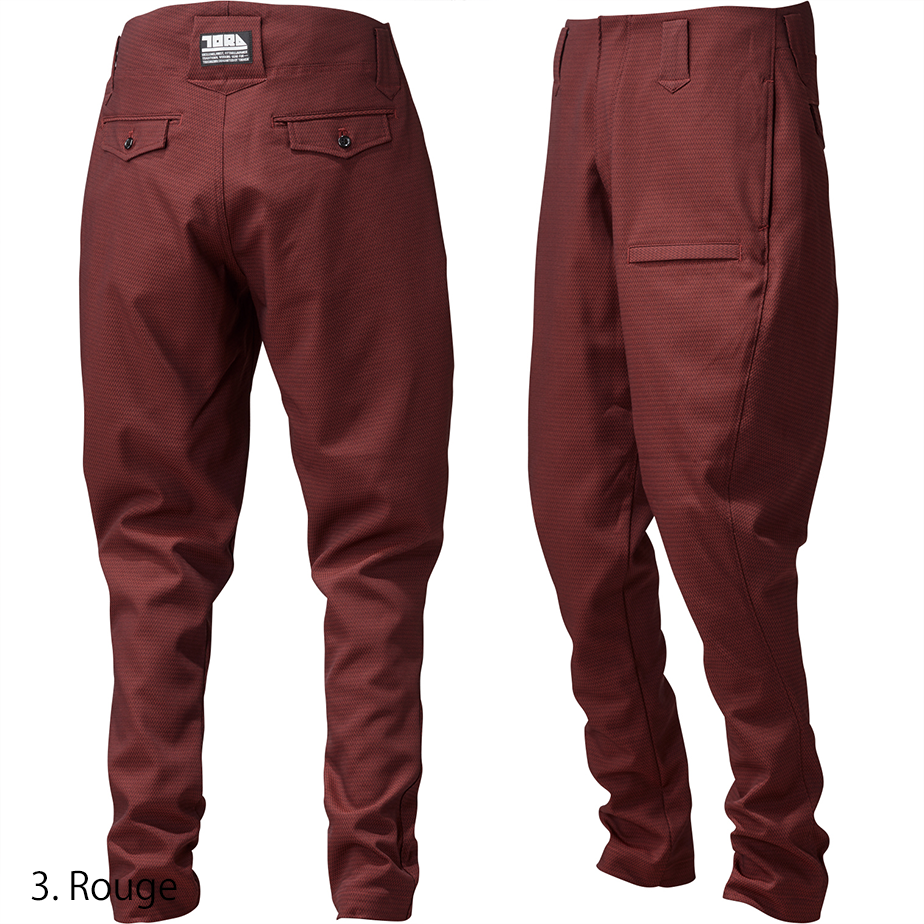 Model demonstrating full-length fit of the Toraichi Torastyle trousers in rouge conveying contemporary Japanese workwear aesthetics.