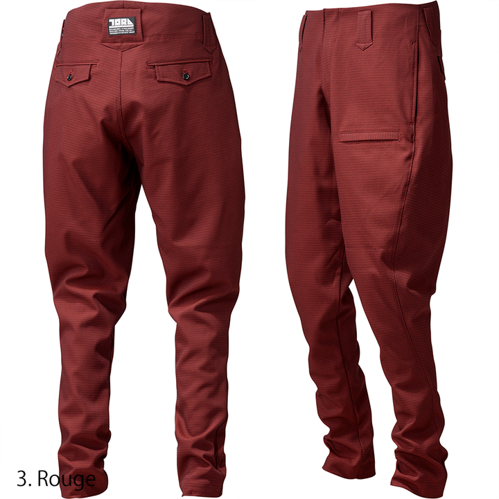 Model demonstrating full-length fit of the Toraichi Torastyle trousers in rouge conveying contemporary Japanese workwear aesthetics.
