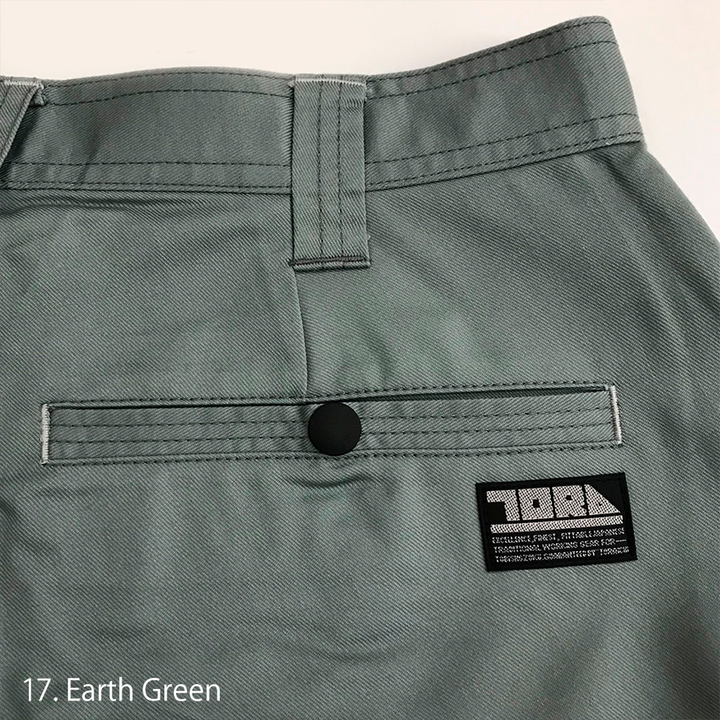 Detailed view of the Toraichi tobi workwear cargo pocket flap with metal snap closure for reliable storage.