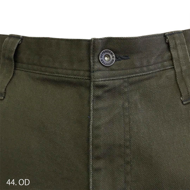 Side angle of stretch cargo pants showing slim tapered silhouette and ergonomic knee design