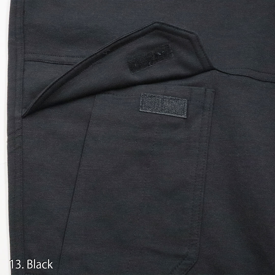 Detailed view of the cargo pocket flap and zipper on the Toraichi tobi workwear trousers demonstrating practical storage and craftsmanship.