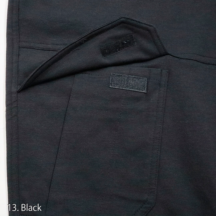 Detailed view of the cargo pocket flap and zipper on the Toraichi tobi workwear trousers demonstrating practical storage and craftsmanship.
