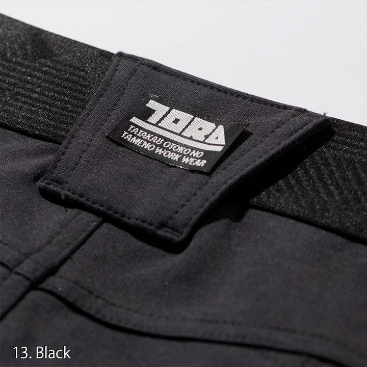 Macro shot of the knee articulation stitching on the Toraichi 9276-235 pants for flexibility during motion.