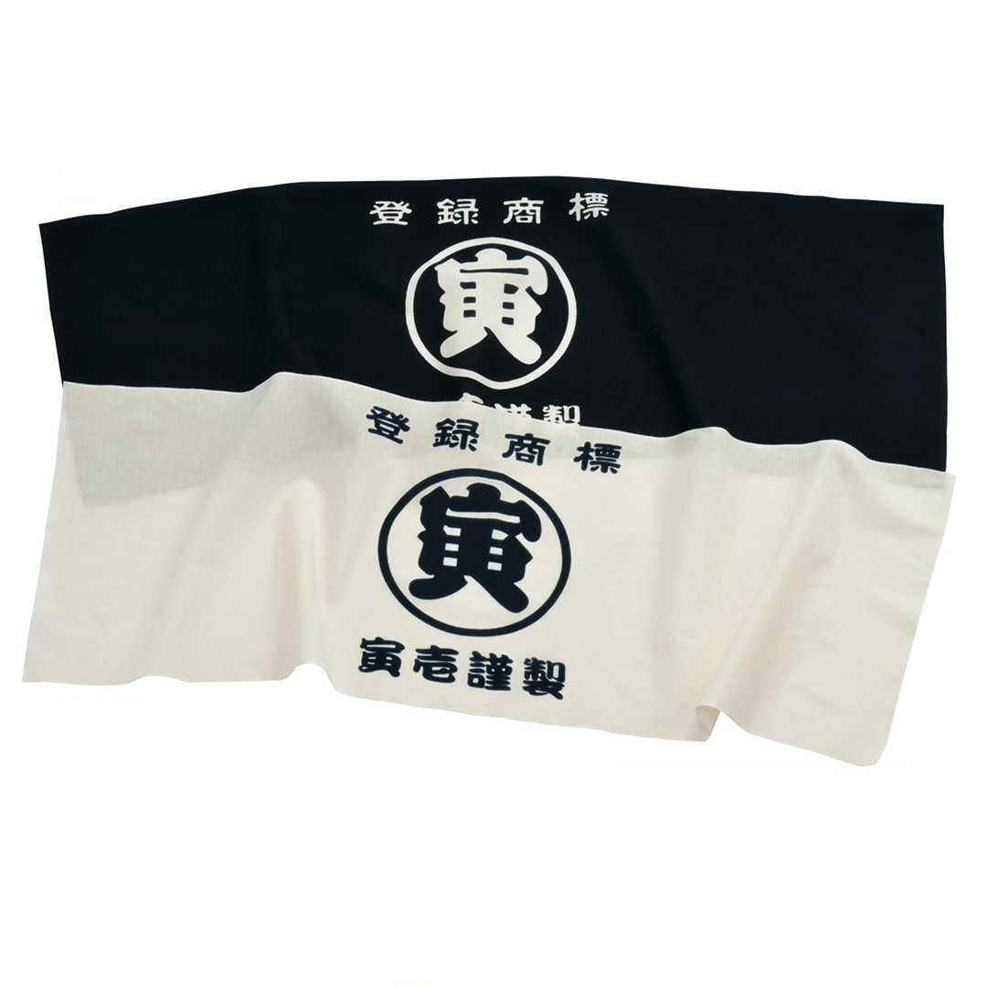 The Toraichi Japanese workwear 9218-962 Marutora Tenugui traditional hand towel in black and white showing classic split-tone design with printed Marutora logo.