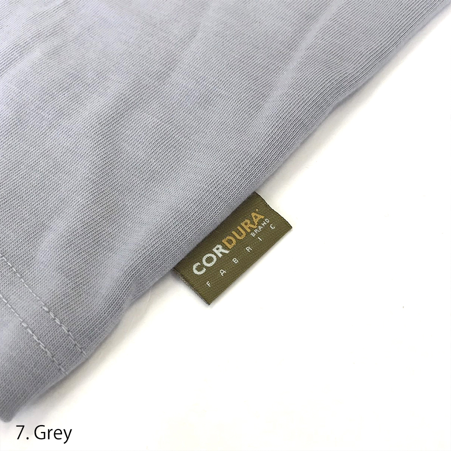Close-up of the hem tag detail on the Toraichi Japanese workwear T-shirt highlighting subtle branding and quality stitching.