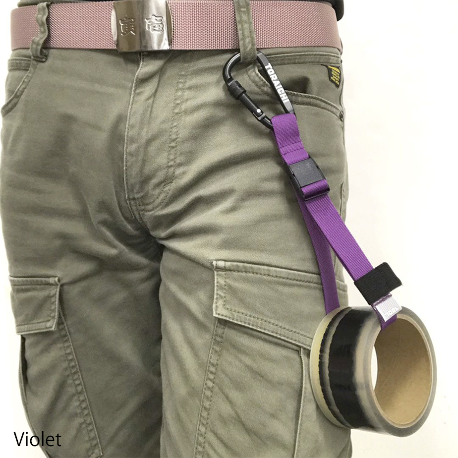 Hand holding Toraichi tape holder carabiner with black logo detail