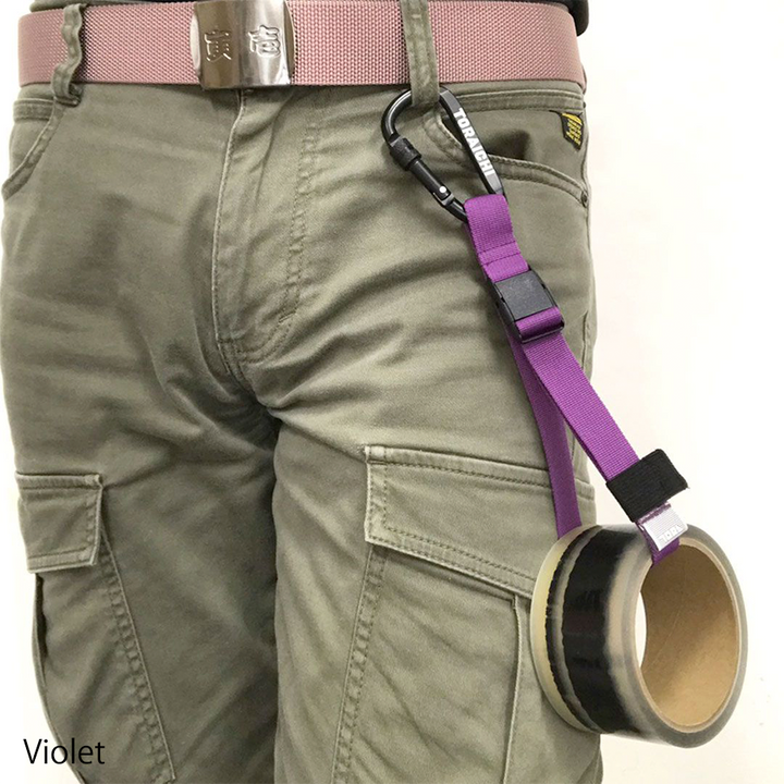 Hand holding Toraichi tape holder carabiner with black logo detail
